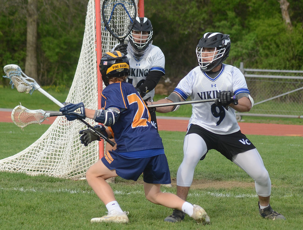 Pine Bush’s Colin Carey looks to score as Valley Central’s Luis Robles (9) defends and goalkeeper Cameron Prutz looks on during Thursday’s boys’ lacrosse game at Valley Central High School in Montgomery.