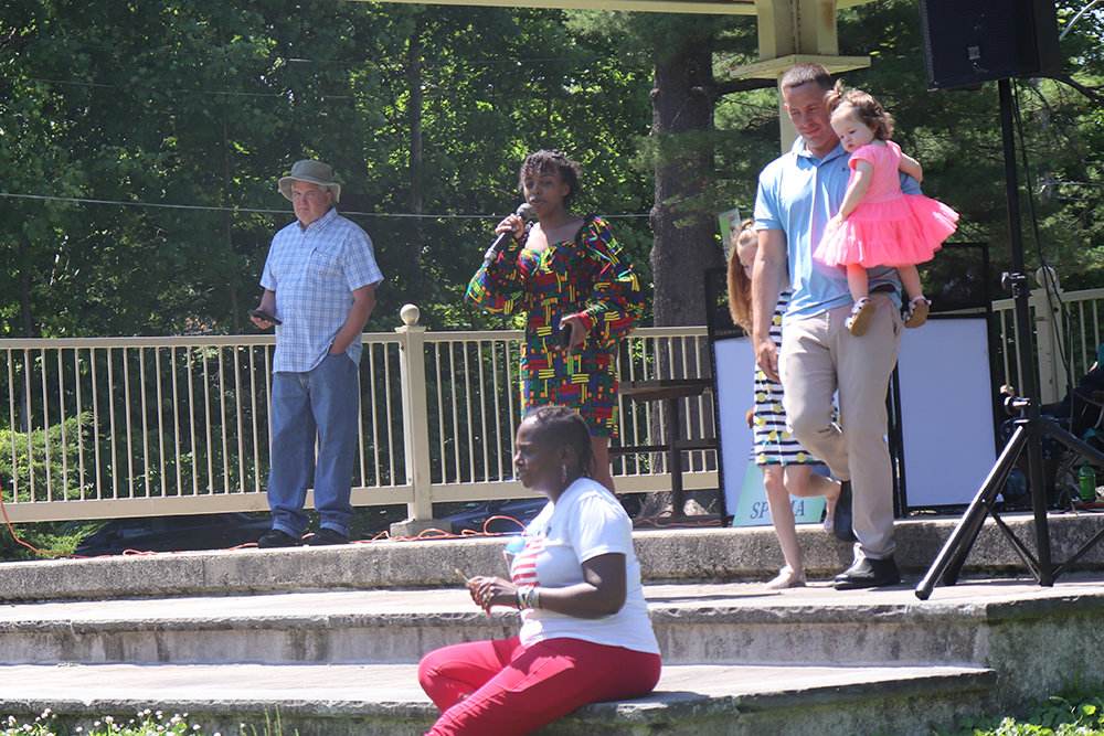 Mercedes Ortiz speaks, as Brian Maher leads his two children offstage at Monday’s Juneteenth event in Walden.