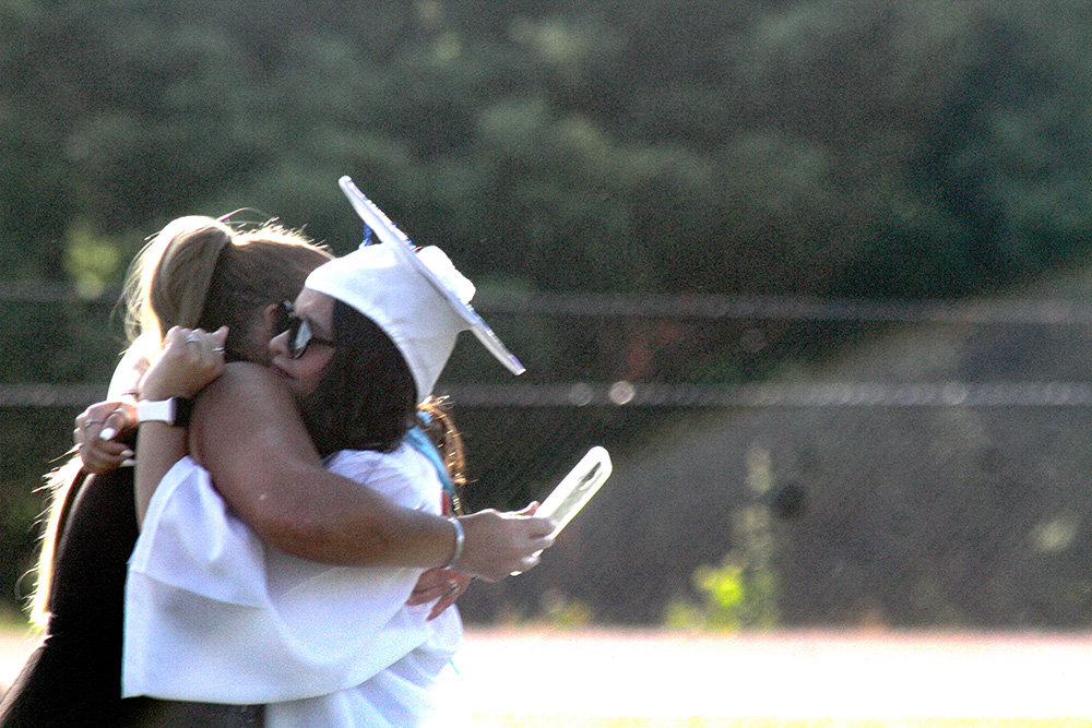 Class President Madison Rivera receives a hug following her remarks.