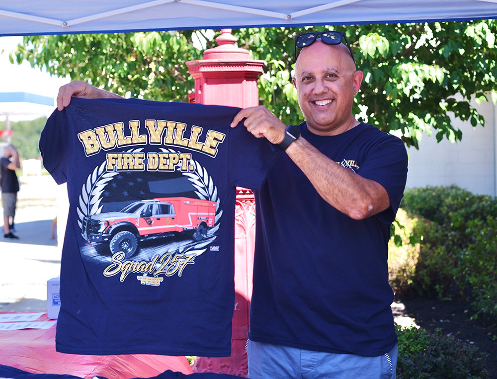 Anthony Borino, Treasurer of the Bullville Fire Department, selling shirts.