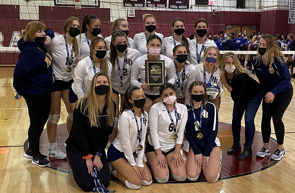 The Pine Bush volleyball team poses with the Section 9 Class AA championship plaque after a 3-2 win over the Monroe-Woodbury Crusaders on Nov. 7, 2021, at James I. O’Neill High School in Highland Falls. The NYSPHSAA last week approved moving to six classifications in seven sports, starting in the 2023-24 school year.