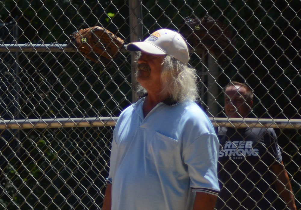 George Hammer, the commissioner of the Montgomery Over 50 Softball League umpires a game between BOOGS and Camouflage on July 23 at Berea Field in Montgomery.