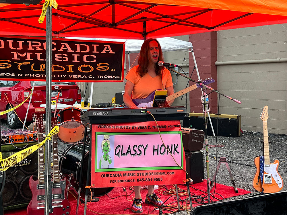 Local artist Glassy Honk performs at the Museum Stage on Main St.