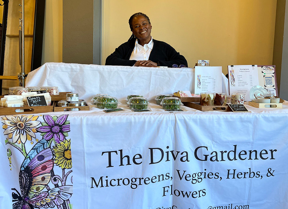 Terry Lassiter, also known as the Diva Gardener, has her booth set with her homegrown microgreens and other various products at APG Pilates.
