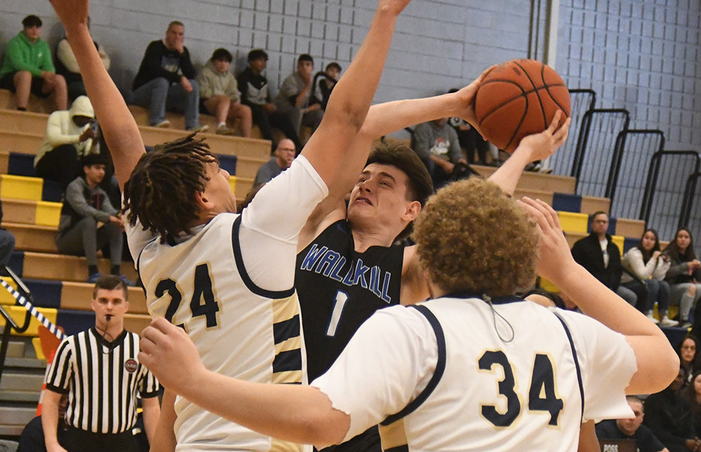 Wallkill's Chris Baccaro goes up for a shot as Beacon's Joseph Battle (24) and Daniel Mercado (34) defend during a Section 9 Class A quarterfinal boys' basketball game on Feb. 27 at Beacon High School.