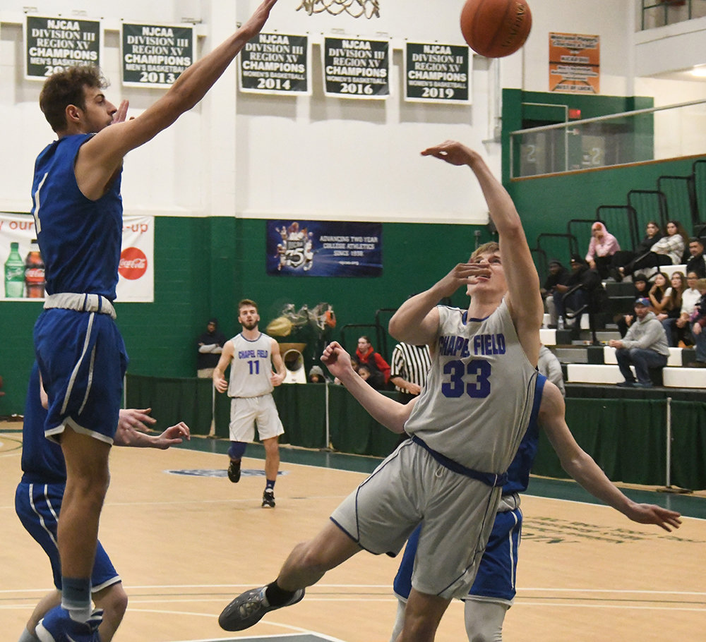 Chapel Field's Jonah McDuffie lays up a shot as Roscoe's Anthony Teipeike defends during Wednesday's Section 9 Class D championship boys' basketball game at SUNY Sullivan in Loch Sheldrake.
