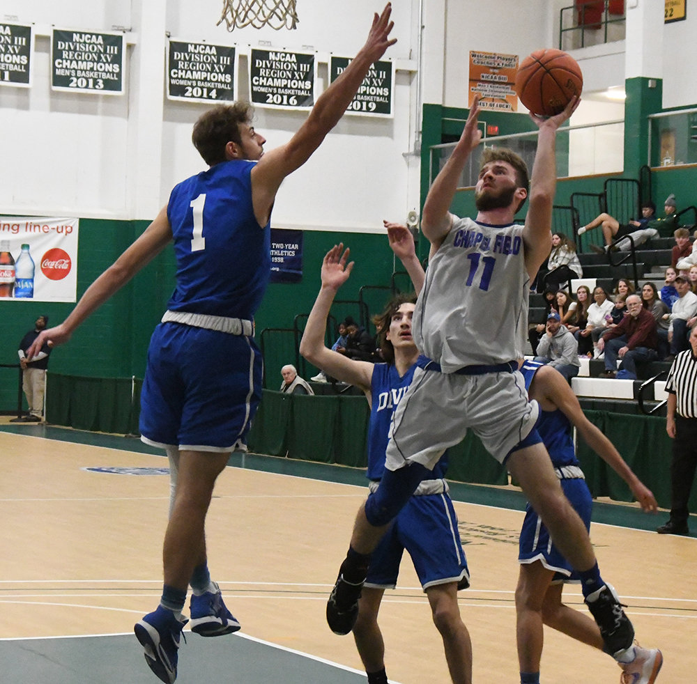 Chapel Field's Mikey Bonagura goes up for a shot as Roscoe's Anthony Teipeike (1), Zach Schwartz (23) and Anthony Zamenick defend during Wednesday's Section 9 Class D championship boys' basketball game at SUNY Sullivan in Loch Sheldrake.