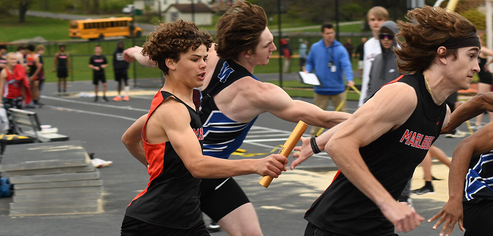 Marlboro’s Sean Robertson hands the baton to Drew Heimink during the boys’ 4x100-meter relay during Friday’s Iron Duke Relays track and field meet at Marlboro High School.