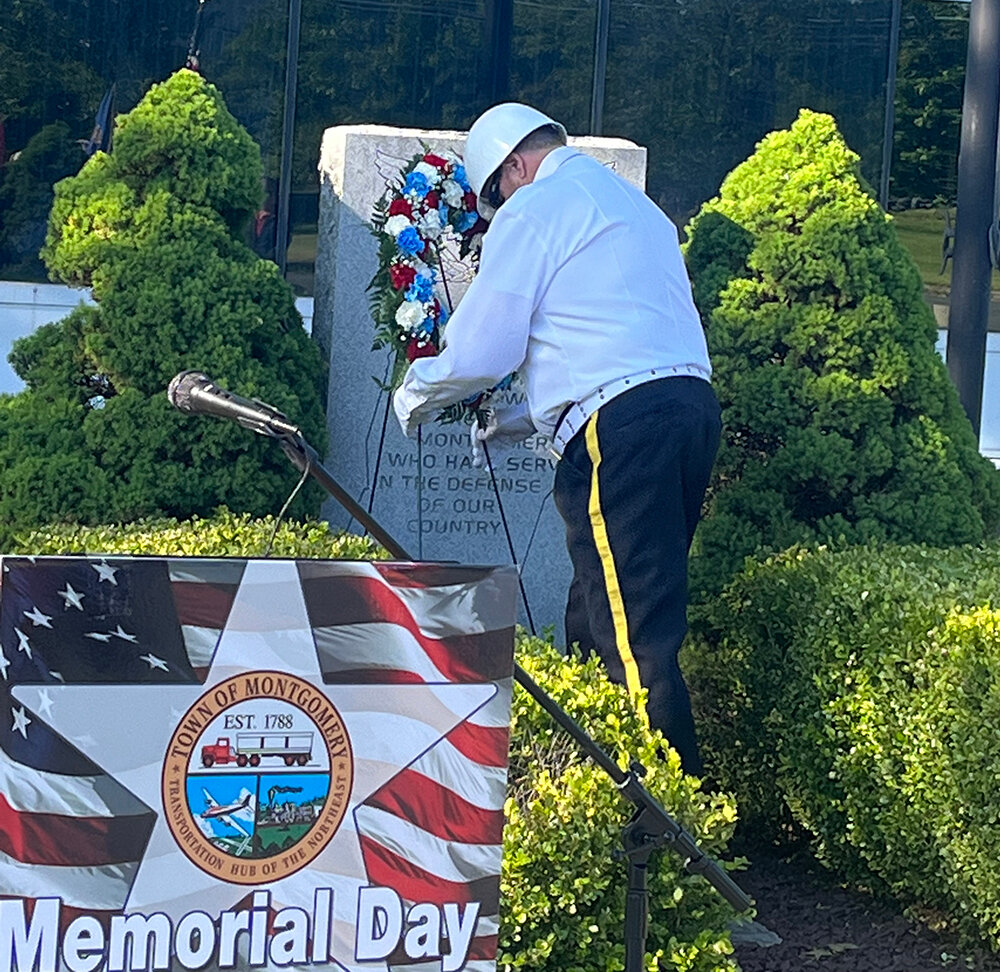 John Luffman, Vietnam Veteran and Purple Heart recipient, places a wreath at the town’s memorial.