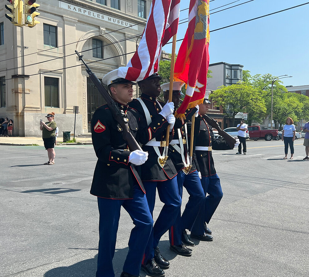 United States Marine Corps Color Guard march down Liberty Street.