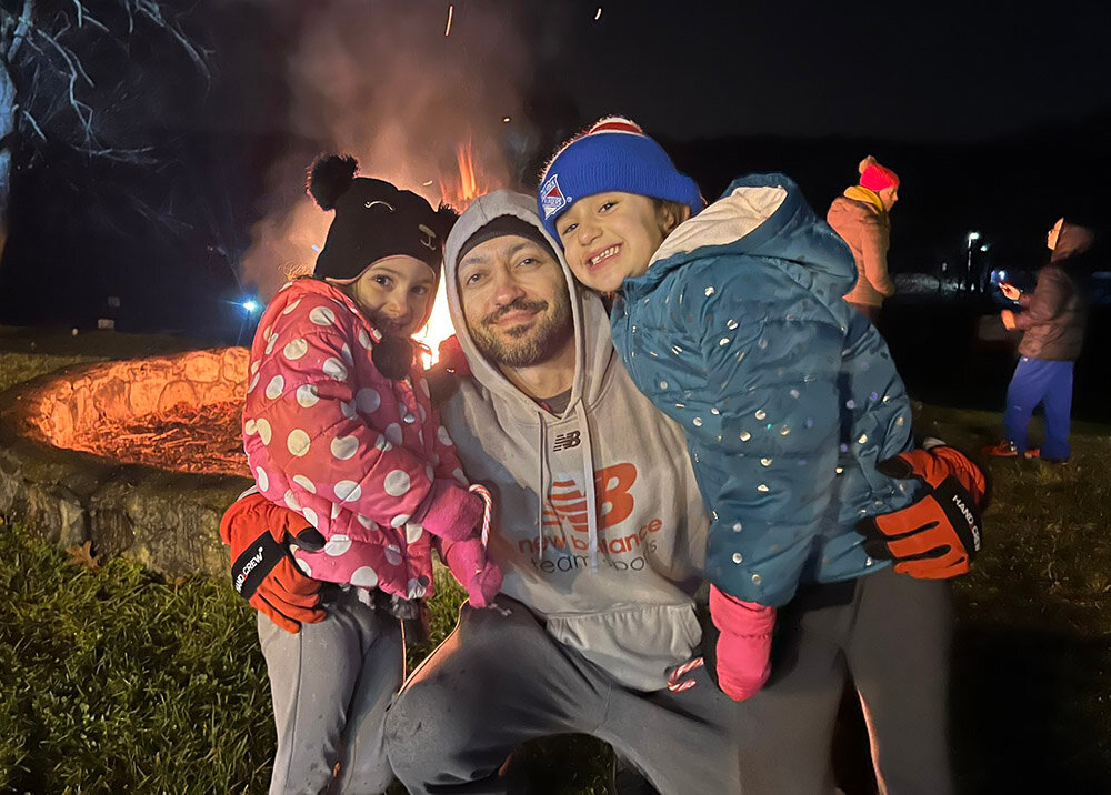 Catellina, Alessandro and Alessandra Viviani enjoy the warmth of the fire at the annual town tree lighting.